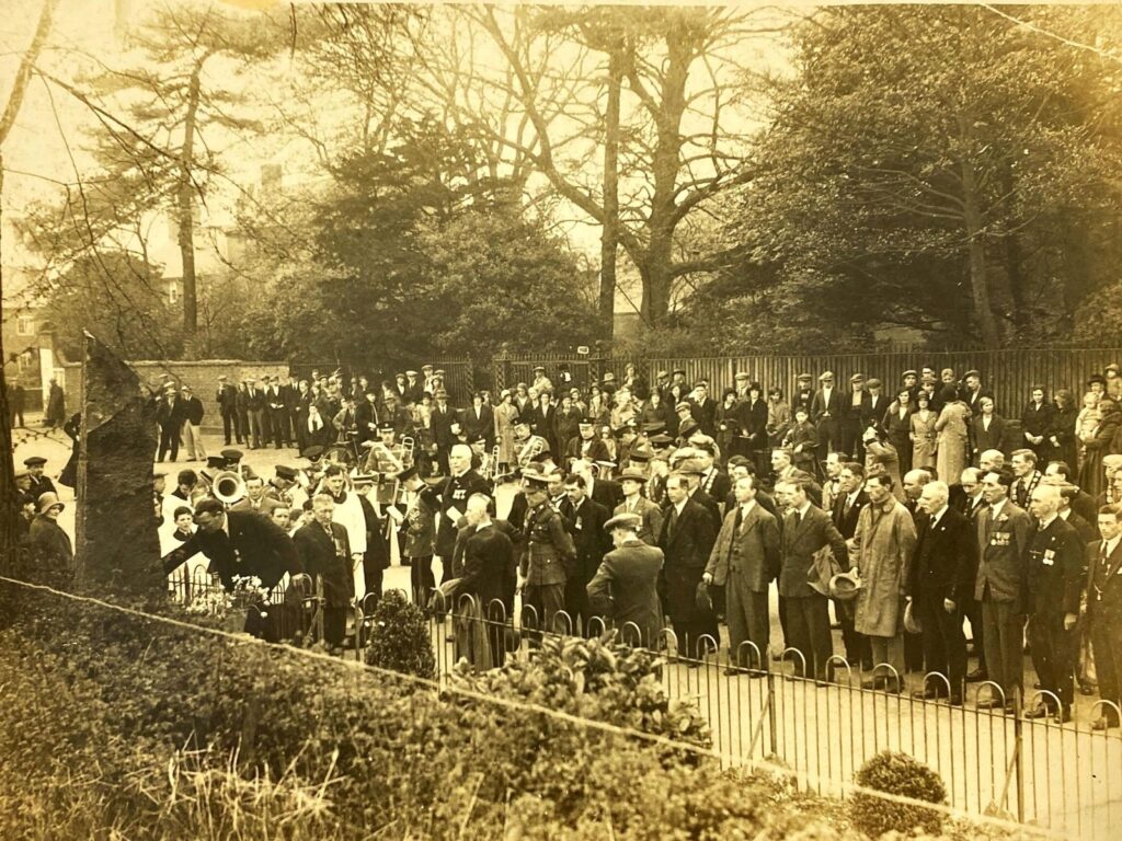 Crowd, band and servicemen gathered at the Newbold Verdon War Memorial on Armistice Sunday in the 1930s, with a wreath being laid